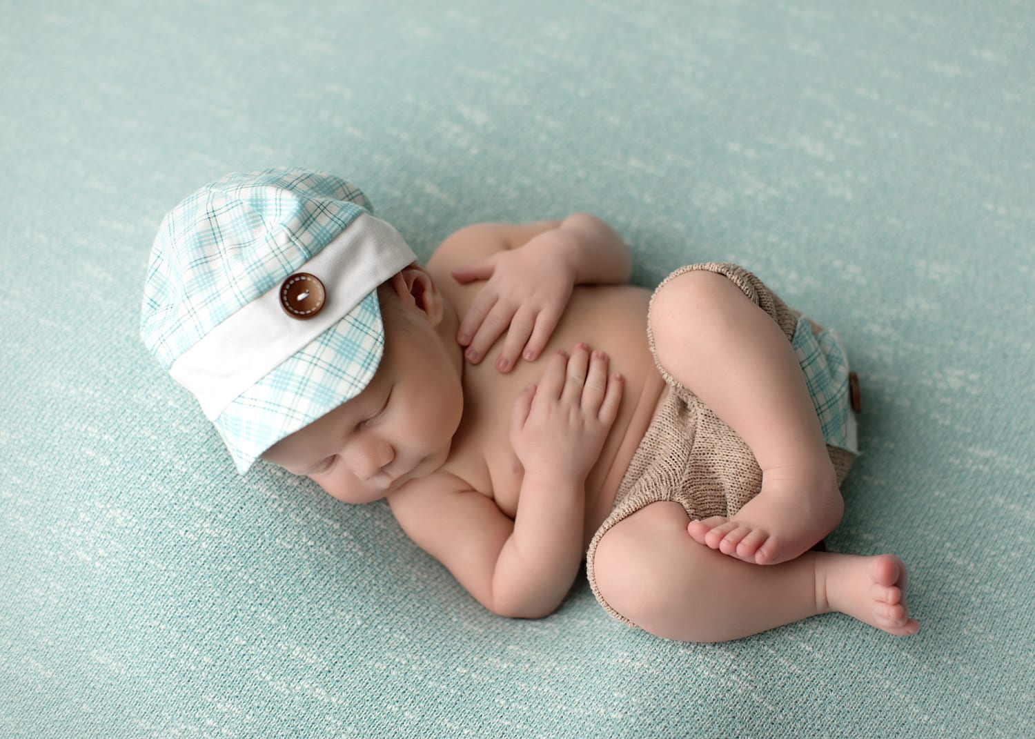 Portland Newborn Photographer baby boy in aqua hat and shorts