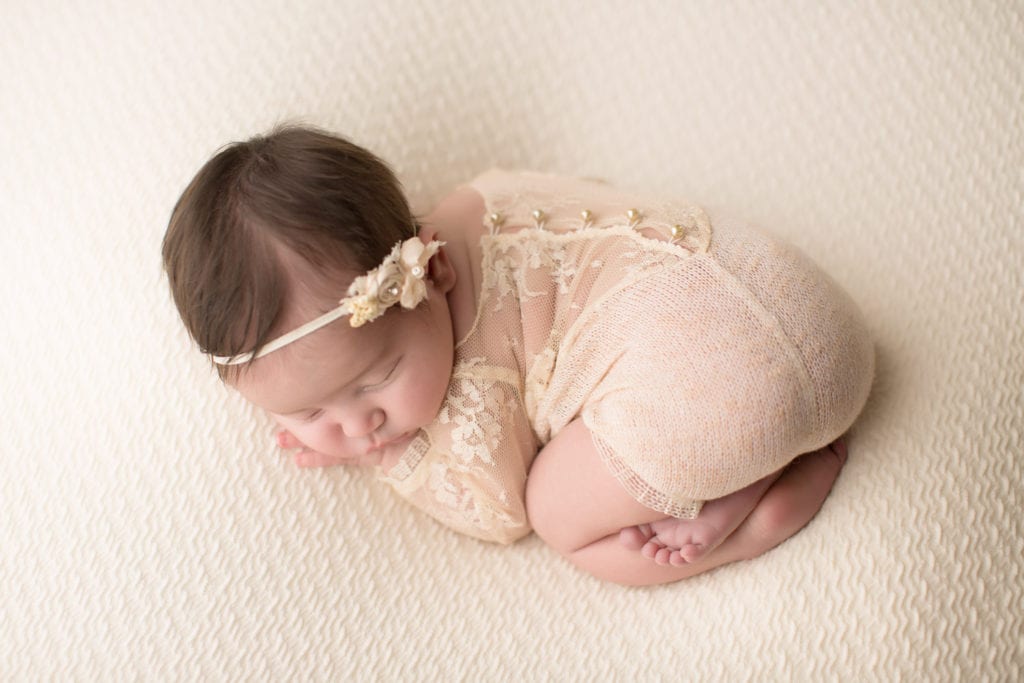 Portland Newborn Photography baby girl in bottoms up pose in lace romper