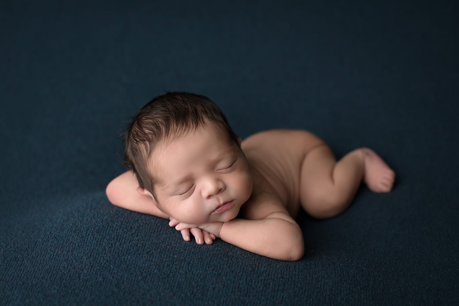 Portland Newborn Photographer baby heads up pose on navy