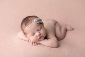 Portland Newborn Photographer baby heads up pose on pink