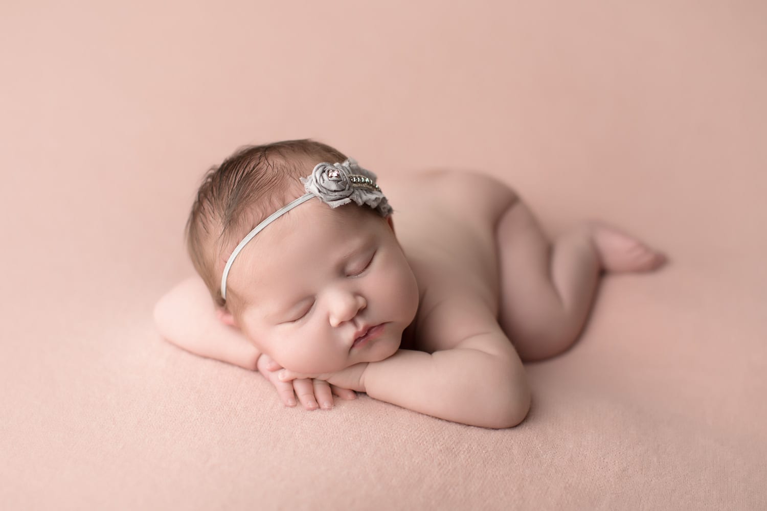 Portland Newborn Photographer baby heads up pose on pink