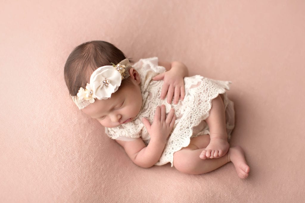  Newborn on back in cream lace dress