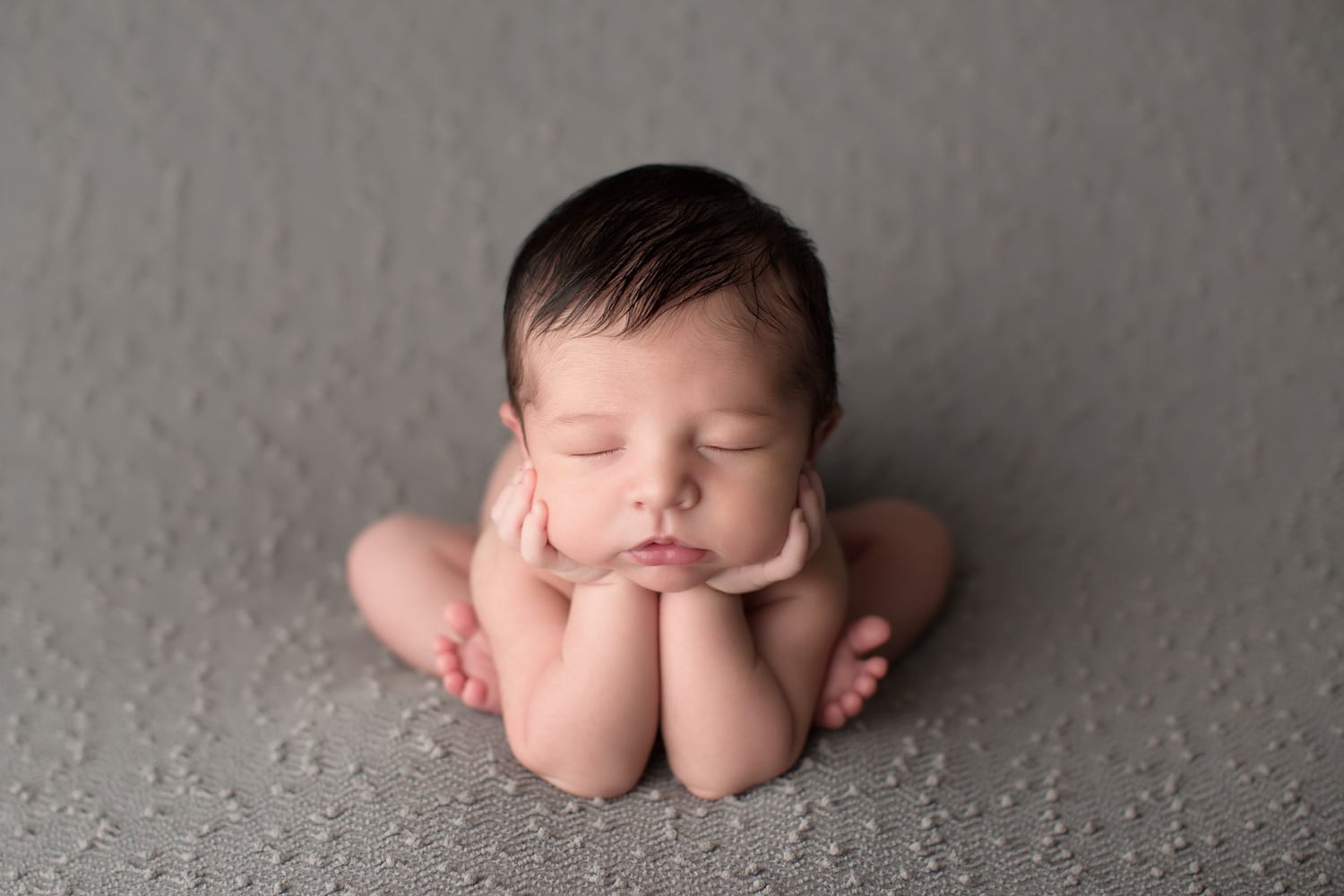 Portland Newborn Photographer baby boy with a lot of hair in froggy pose