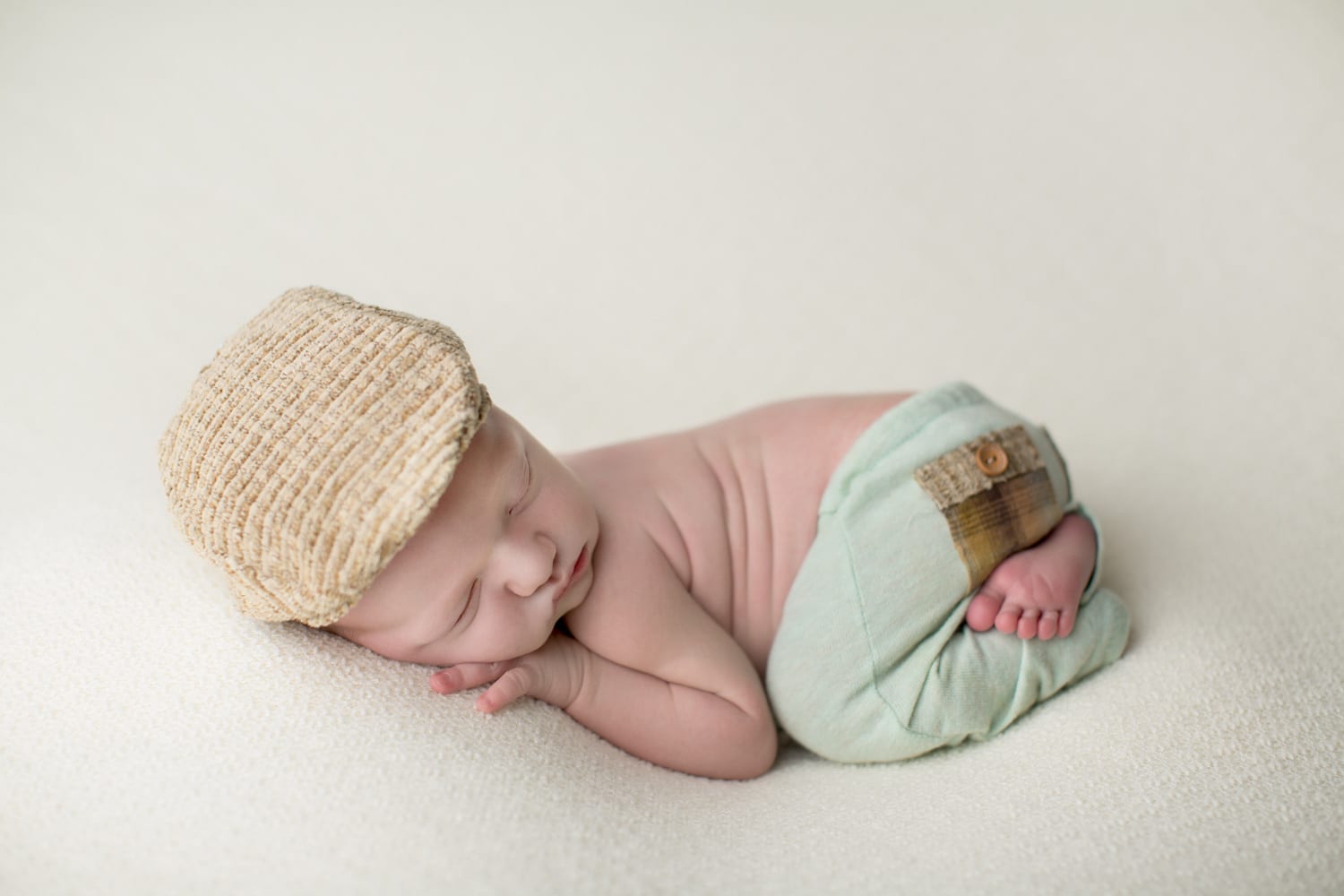 Portland Newborn Photographer Baby boy in green pants and hat