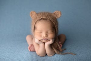 Portland Newborn Photographer baby in froggy pose with bear hat