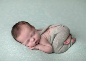 Portland Newborn Photographer baby in gray overalls