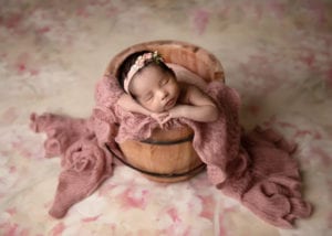 Portland Newborn Photographer baby in bucket with floral backdrop