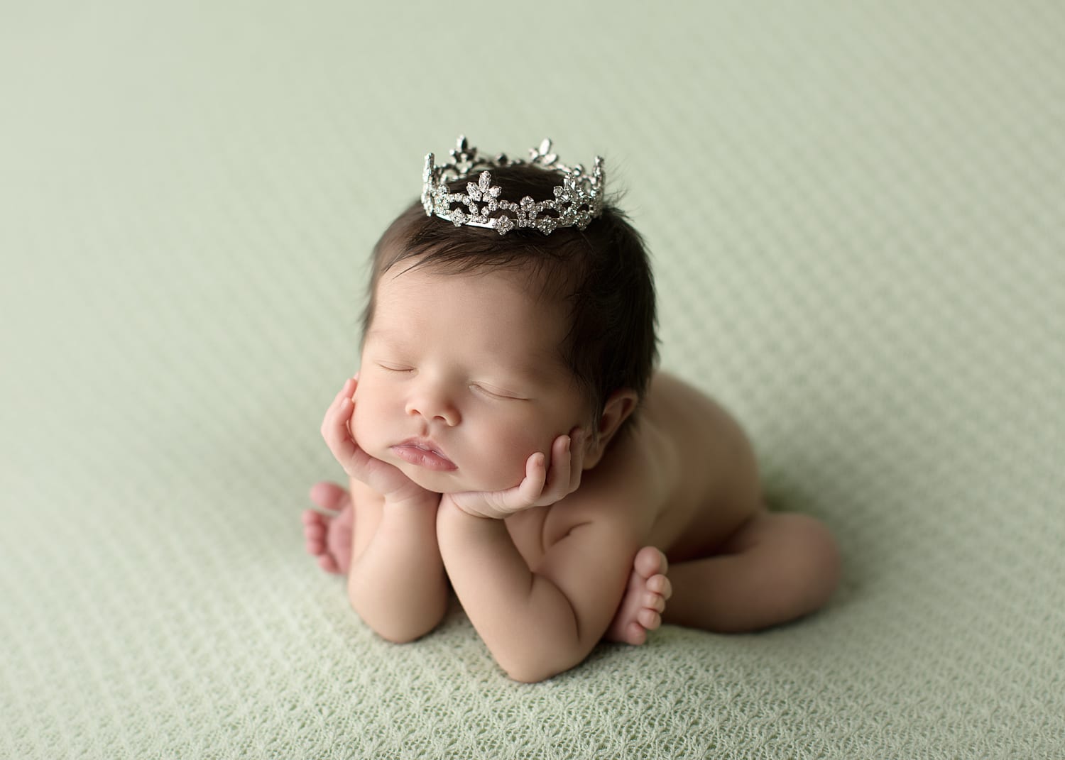 Portland Newborn Photographer Newborn on mint side angle groggy pose