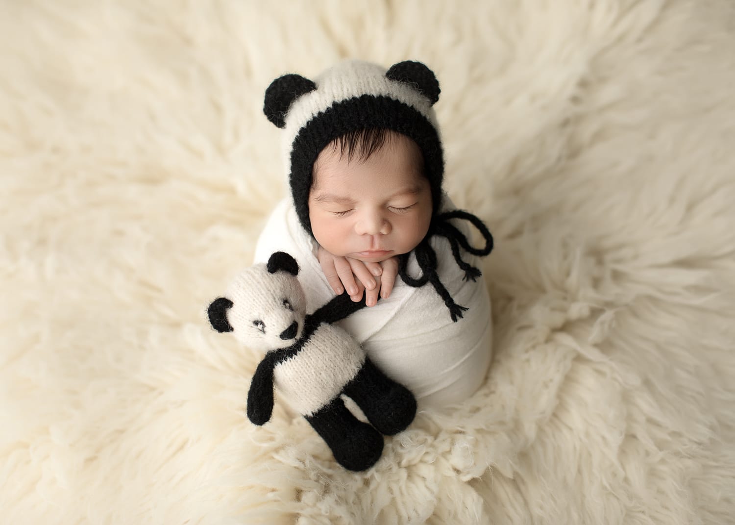 Portland Newborn Photographer Baby in Potato Sack pose holding panda