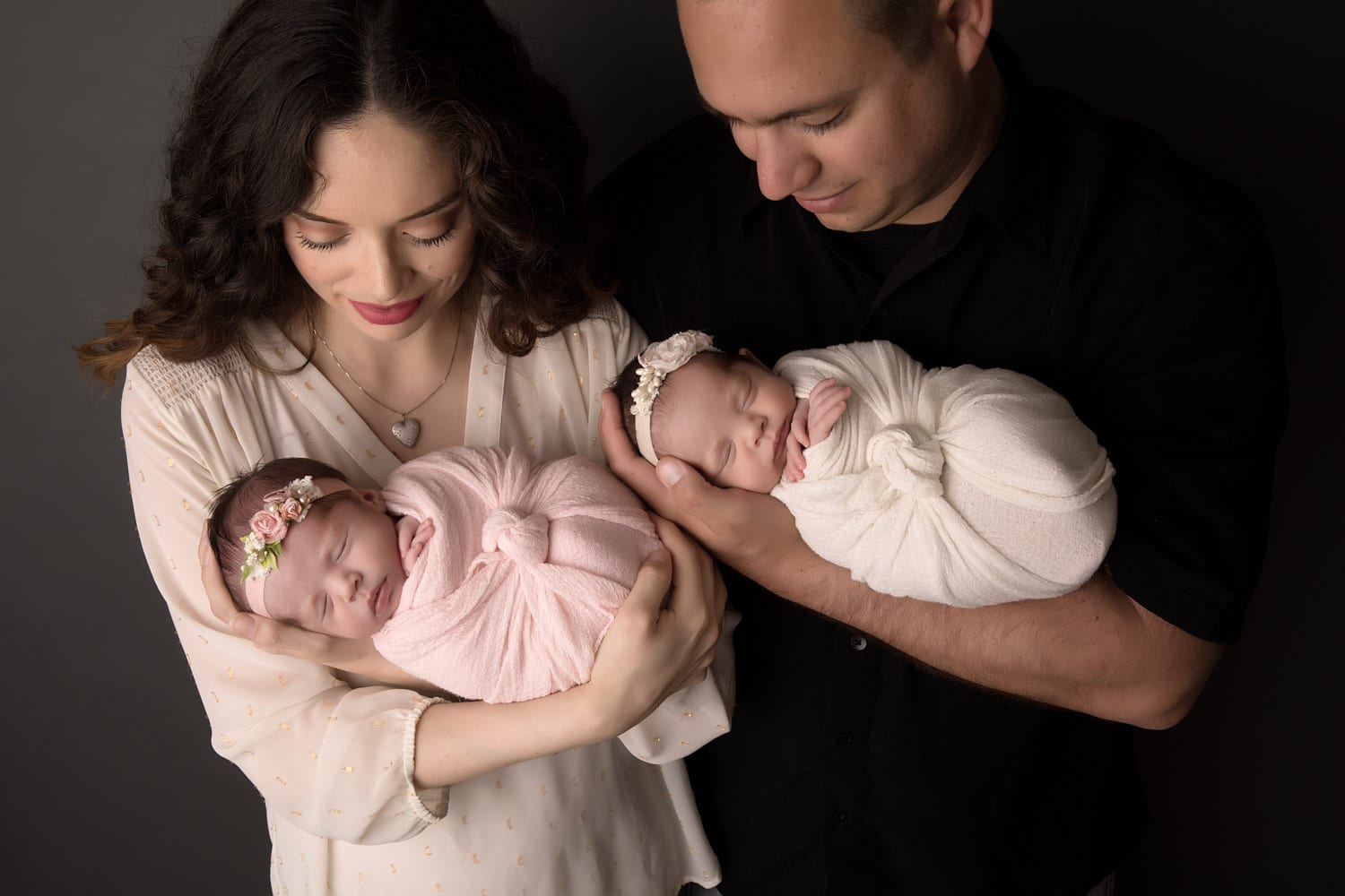Portland Newborn Photographer parents holding swaddled twins