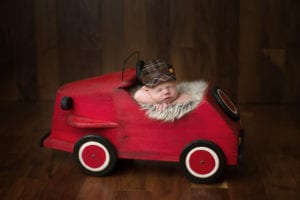Portland Newborn Photographer baby in red car