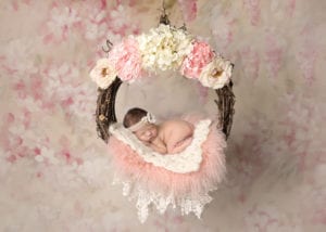 Portland Newborn Photographer Baby in floral Swing with pink and white flowers
