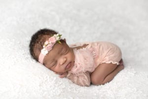 Portland Newborn Photographer Baby in Pink romper on white