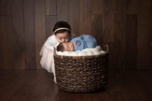 Portland Newborn Photographer sister kissing new brother