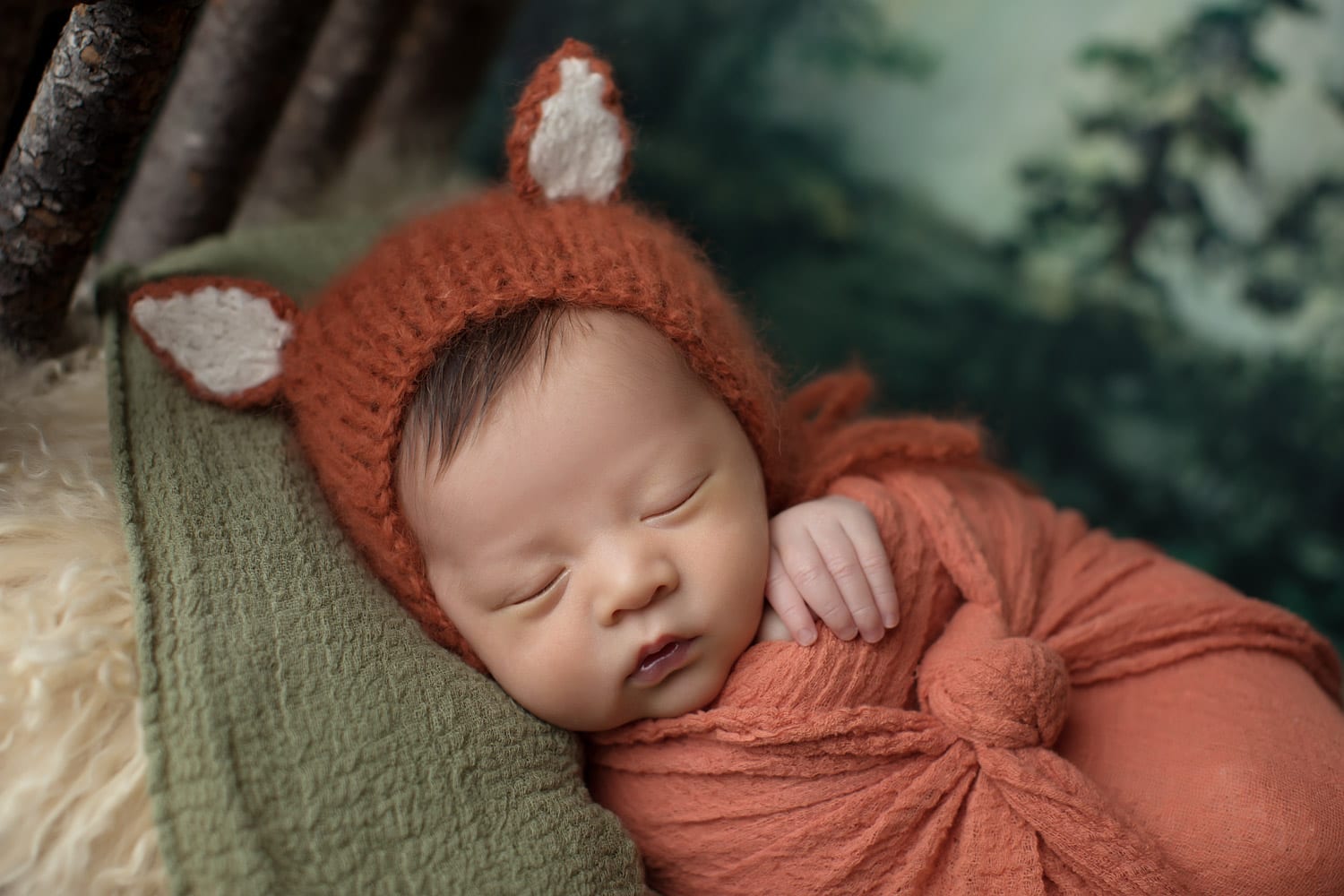 Portland Newborn Photographer swaddled newborn in fox hat