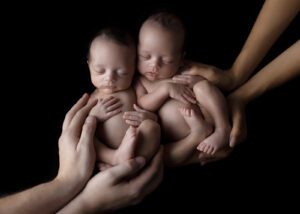 Portland Newborn Photographer Twins in parents hands